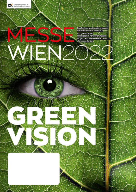 Das Bild zeigt ein Plakat für die Messe Wien 2020 mit dem Thema "Green Vision". Im Vordergrund ist ein Auge zu sehen, das von grünen Pflanzen umgeben ist. Das Plakat ist an einem Metallzaun befestigt.